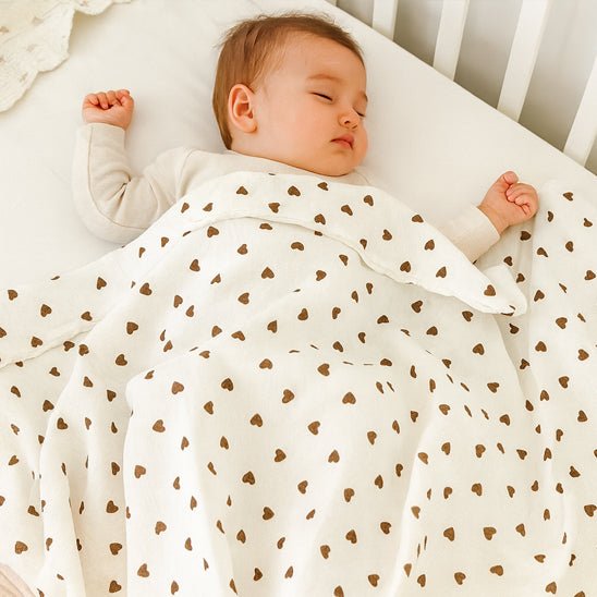 bébé dors avec la couverture cœur